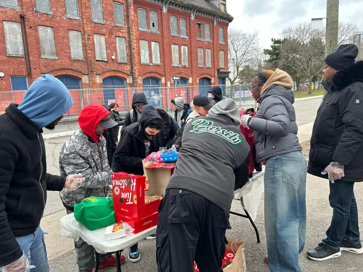 Volunteers handing out supplies to community members in Toronto